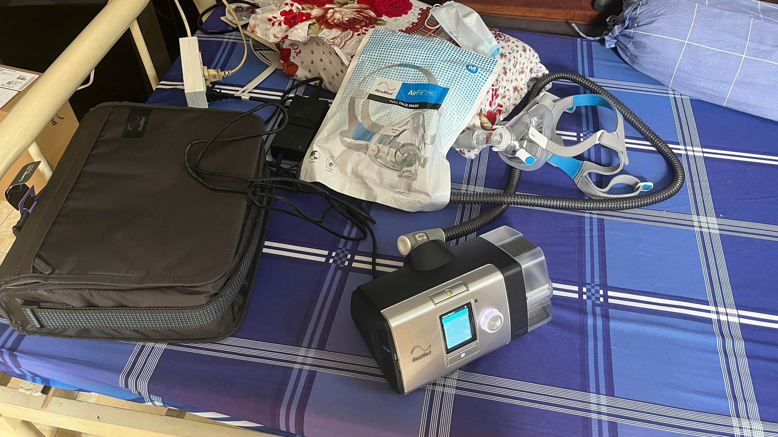 A complete setup for a clinical CPAP machine rental in Ho Chi Minh City, featuring a ResMed device, tubing, and a sealed mask interface.